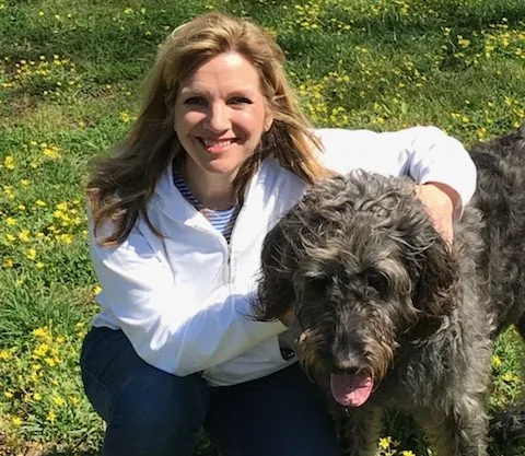 Laura Thomae Young with her dog Val outdoors